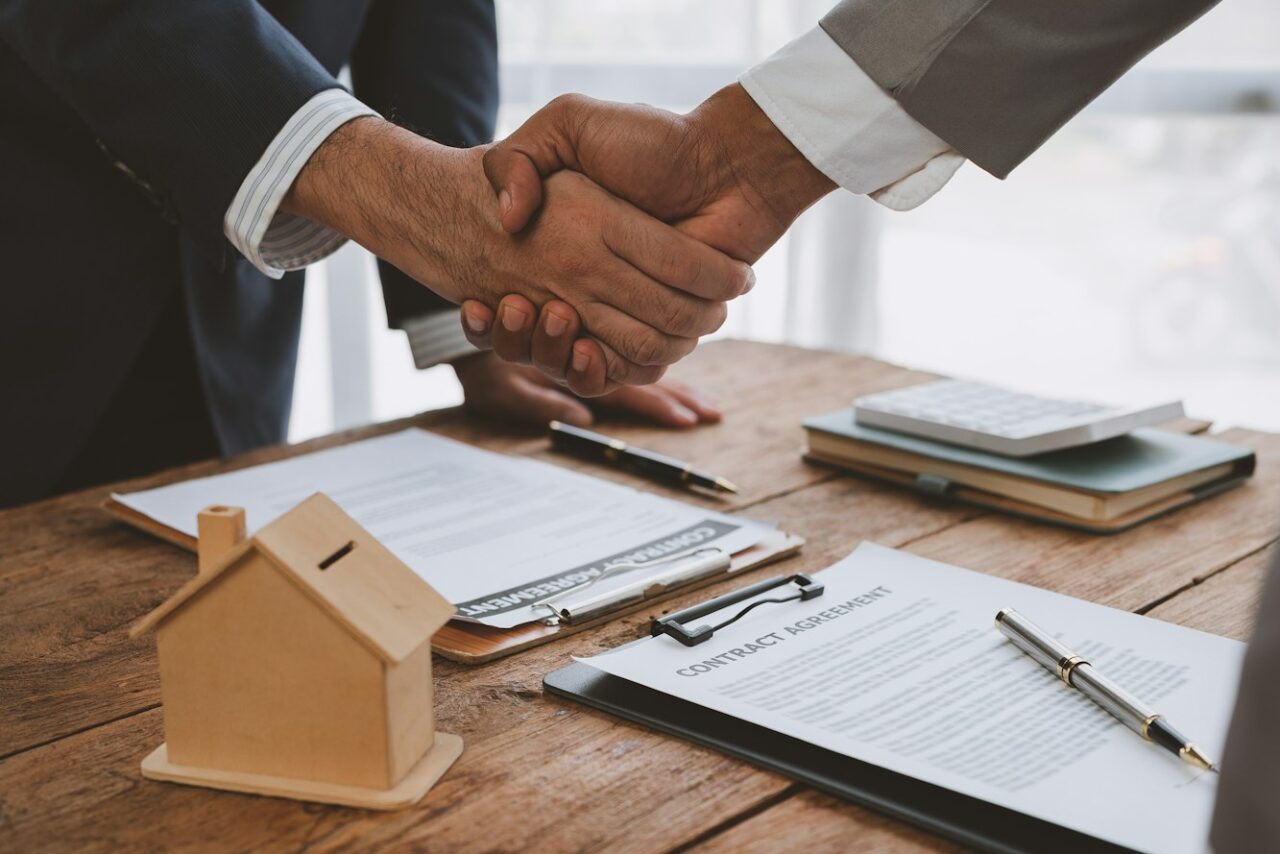 Handshake of real estate brokers with customers or investors, mortgage loan agreements Make a lease-